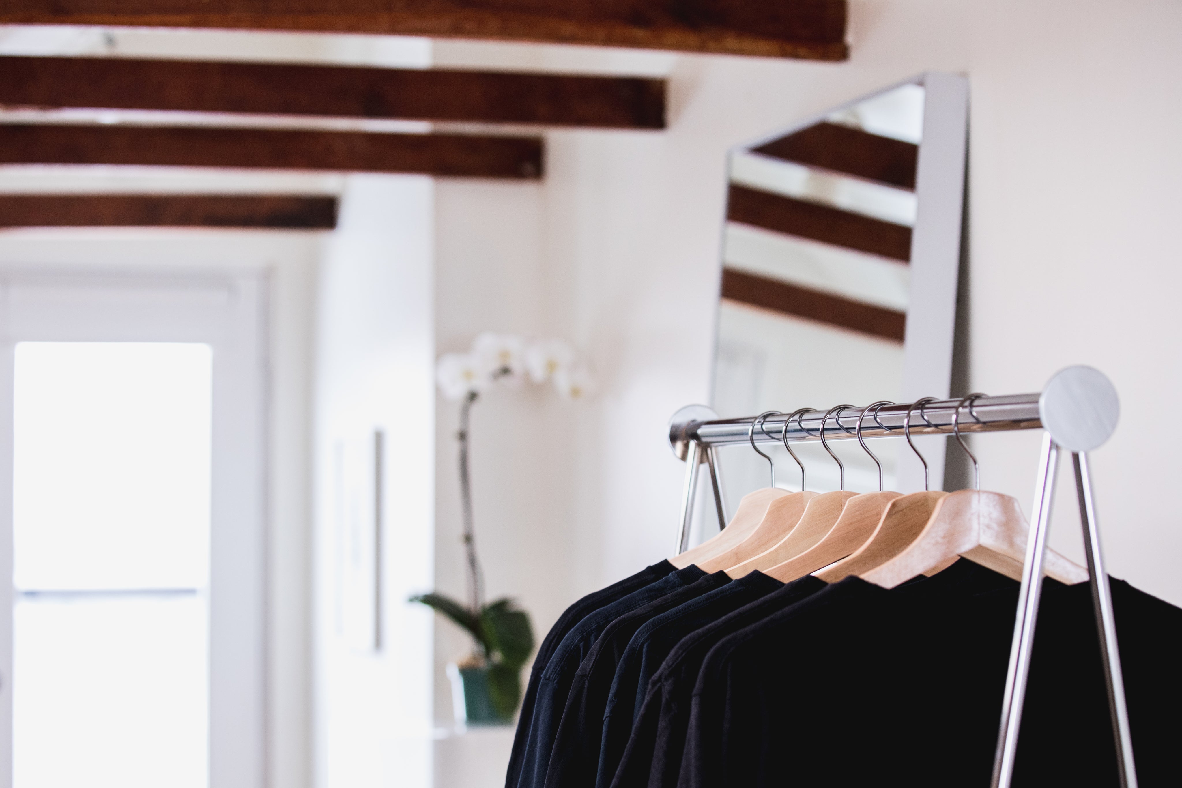 clothing-on-a-shop-rack-with-flowers-in-the-background.jpg